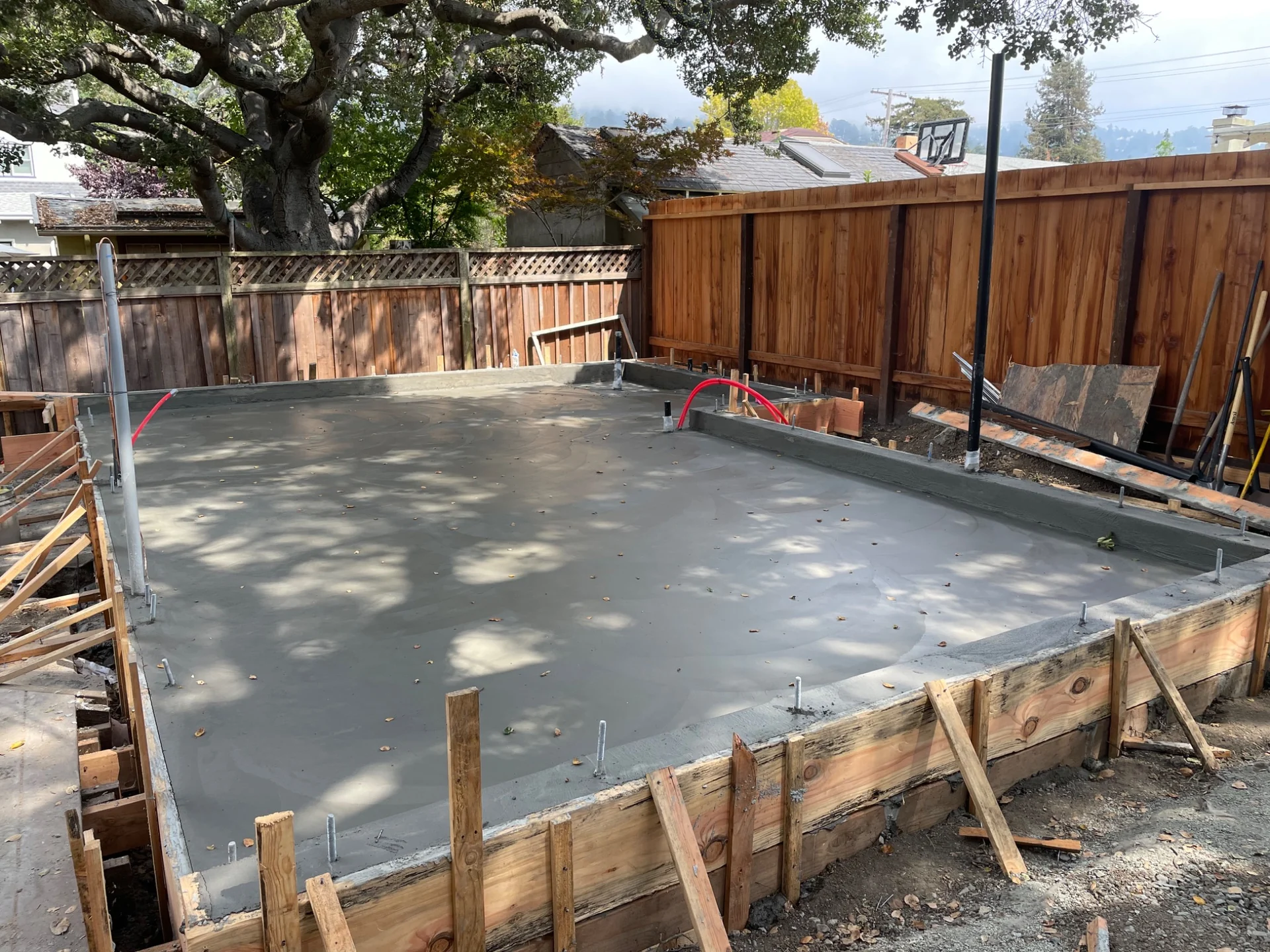 Fresh concrete foundation slab and perimeter formwork for the Thousand Oaks ADU.